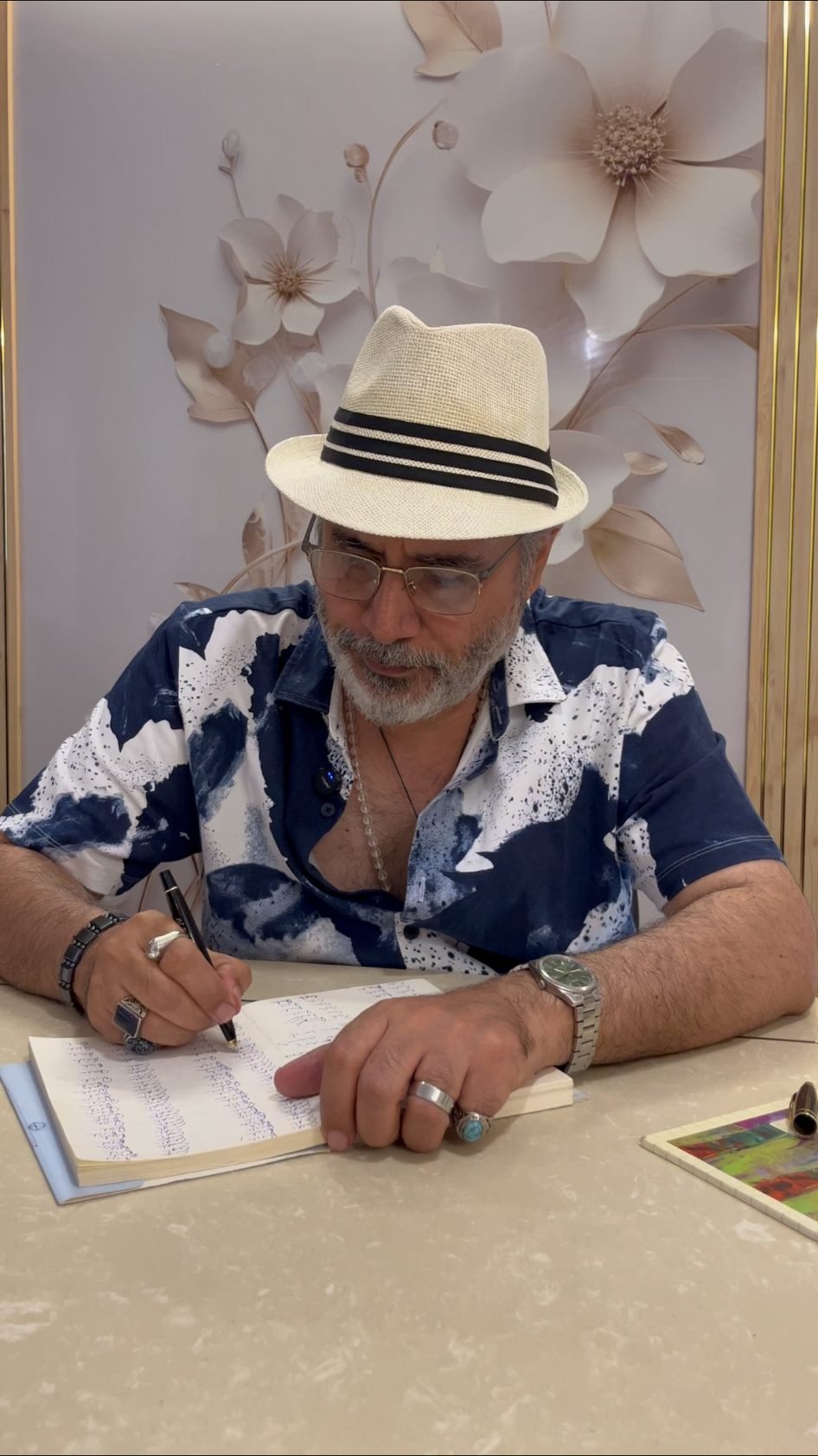Manu Shandilya Ji writing names and dates in a notebook